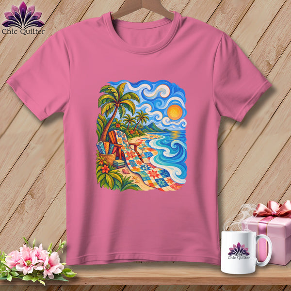 A pink t-shirt hangs on a hanger, featuring a colorful tropical beach landscape illustration centered on the chest.