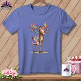 Periwinkle t-shirt featuring a cute cartoon moose wearing a colorful quilt and hanging ornaments from its antlers.