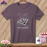 T-shirt with quilt, needle, thread, and scissors. Text reads 