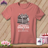 T-shirt with a graphic featuring a stack of fabric, scissors, and text 