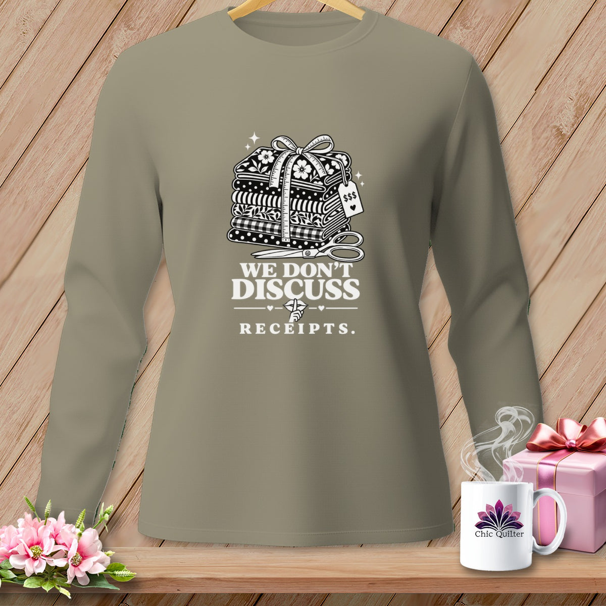 Long-sleeve shirt with stacked fabric and "We Don't Discuss Receipts" text.