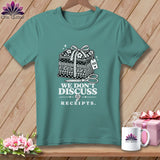T-shirt with stacked fabric bundles, scissors, and text 