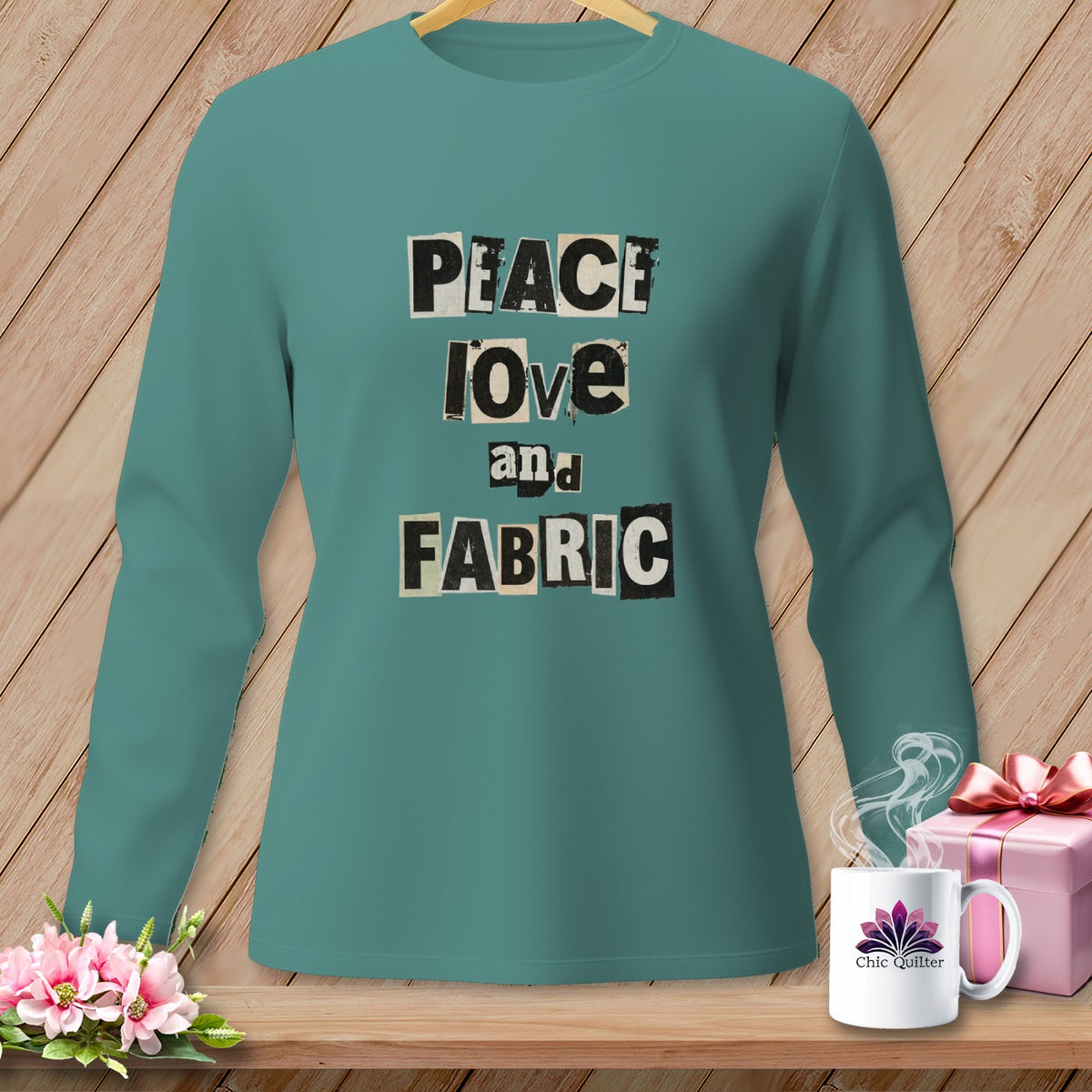 Teal long-sleeved shirt with "Peace Love and Fabric" text and a mug.