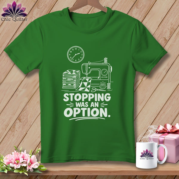 Green t-shirt with sewing machine, fabric stack, and "Stopping Was An Option" text.