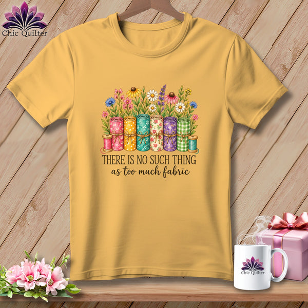 Gold crewneck t-shirt featuring a graphic of rolled fabric, flowers, and text reading There is no such thing as too much fabric.