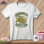 A white t-shirt hanging on a wooden background, featuring a Jacksonville Quilter graphic with a jaguar illustration.