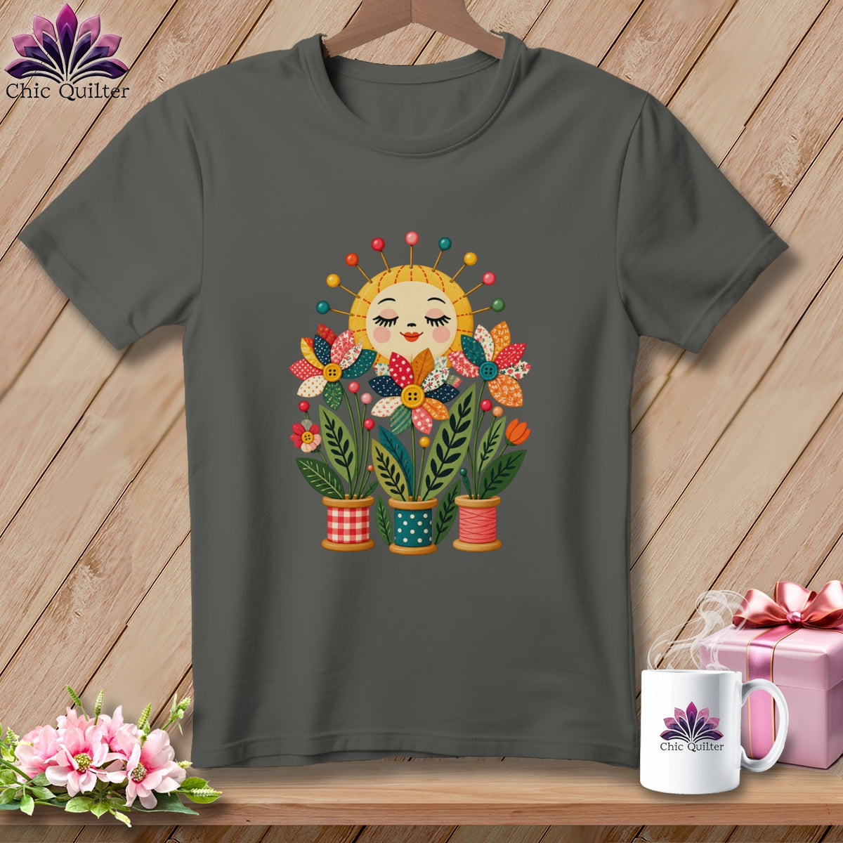 Dark grey t-shirt featuring a graphic of a smiling sun and quilted flowers in spool pots.