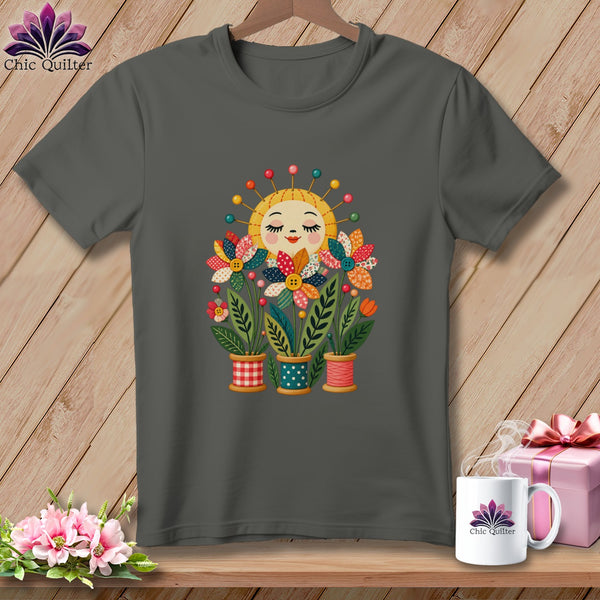 Dark grey t-shirt featuring a graphic of a smiling sun and quilted flowers in spool pots.