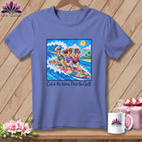 Periwinkle t-shirt featuring a graphic of three women surfing together and the text Catch the Wave, Piece the Quilt.