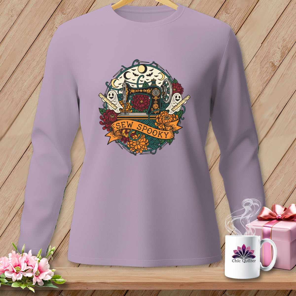 Purple long-sleeve shirt with a circular Halloween-themed graphic featuring a sewing machine and "Sew Spooky" text.