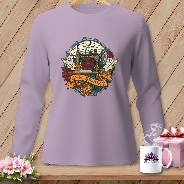 Purple long-sleeve shirt with a circular Halloween-themed graphic featuring a sewing machine and "Sew Spooky" text.