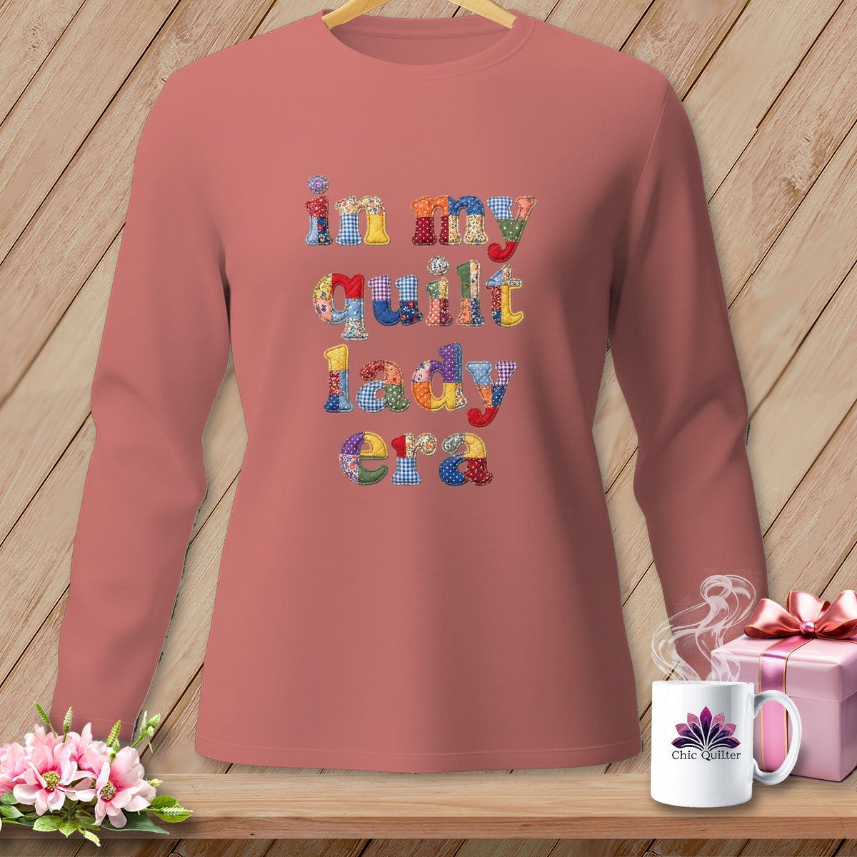 Long-sleeved shirt with "in my quilt lady era" text in patchwork fabric letters.
