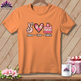 Orange t-shirt featuring a peace sign, heart, stacked fabric, and the text Peace Love Fabric.