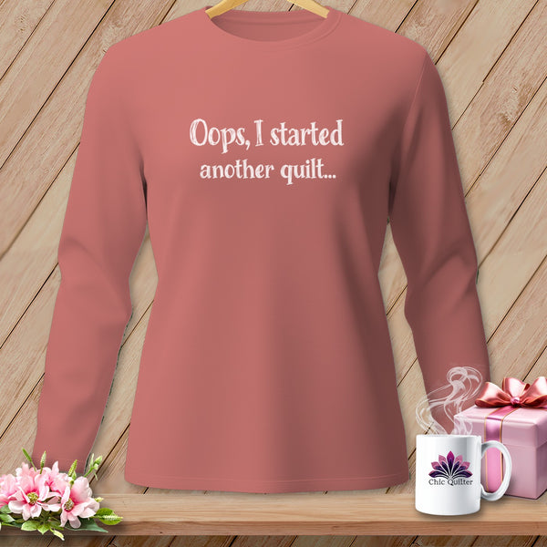 Long-sleeve t-shirt with "Oops, I started another quilt..." text in white.