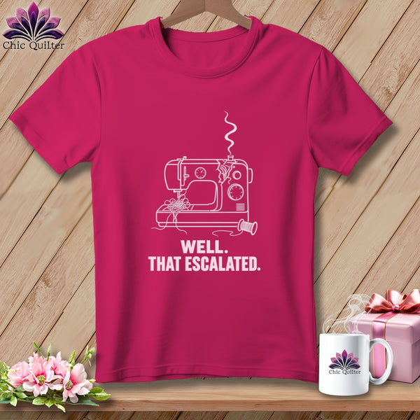 Pink t-shirt with line art of a sewing machine and text "WELL. THAT ESCALATED."