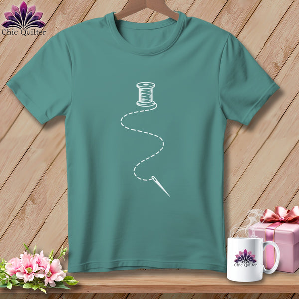 Teal t-shirt with white spool of thread and needle graphic.