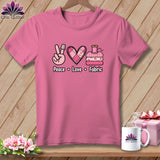 Pink t-shirt featuring a quilting graphic with peace sign, patchwork heart, and folded fabrics above the text Peace Love Fabric.