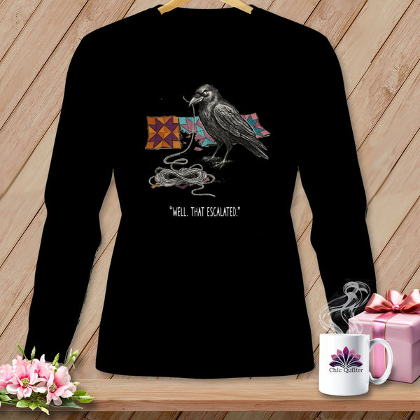 Black long-sleeve shirt with a crow, quilt squares, and text "WELL, THAT ESCALATED."