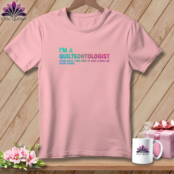 Pink t-shirt with "I'm a Quilteontologist" text and quilting humor.
