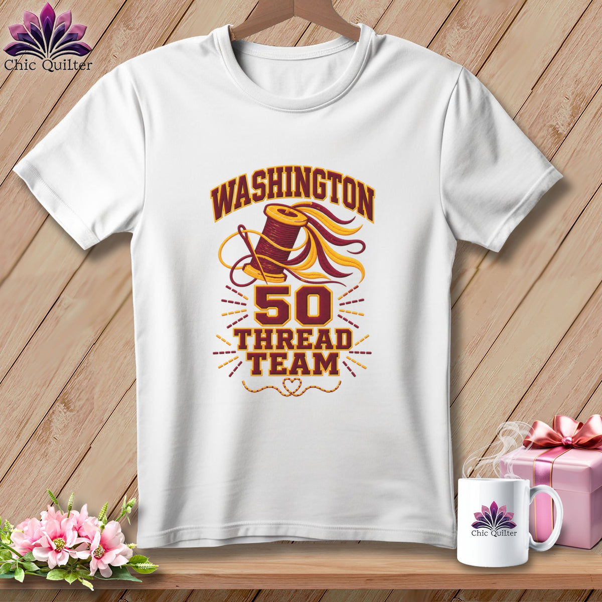 White short-sleeved t-shirt hanging on a wooden background, featuring graphic text reading WASHINGTON 50 THREAD TEAM.