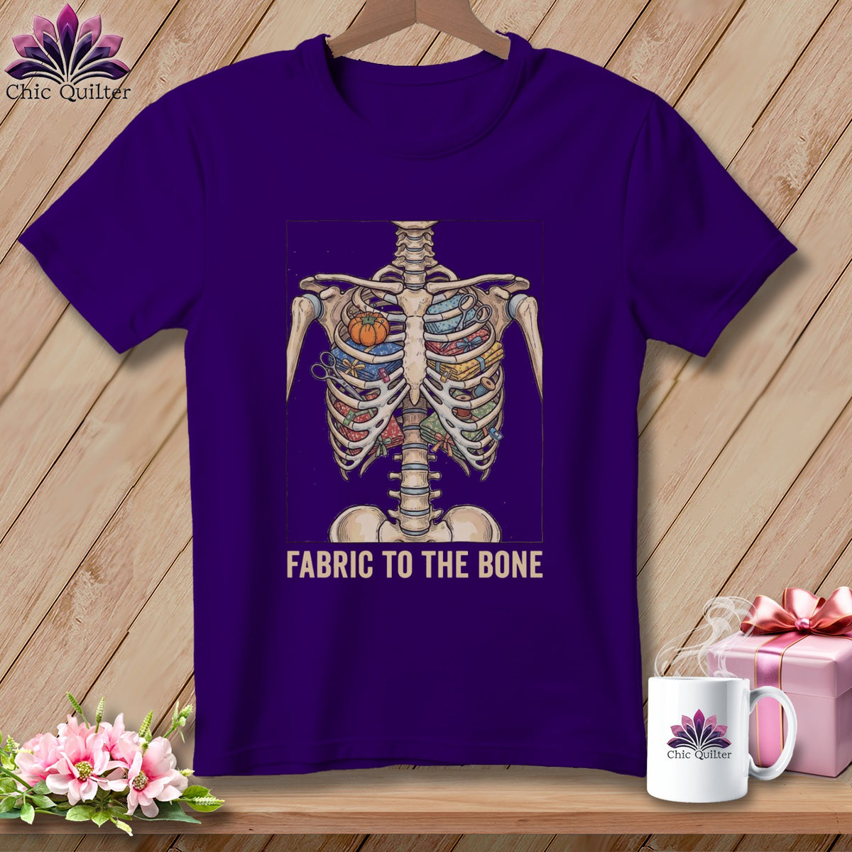 Purple t-shirt featuring a skeleton chest filled with fabric and sewing notions.