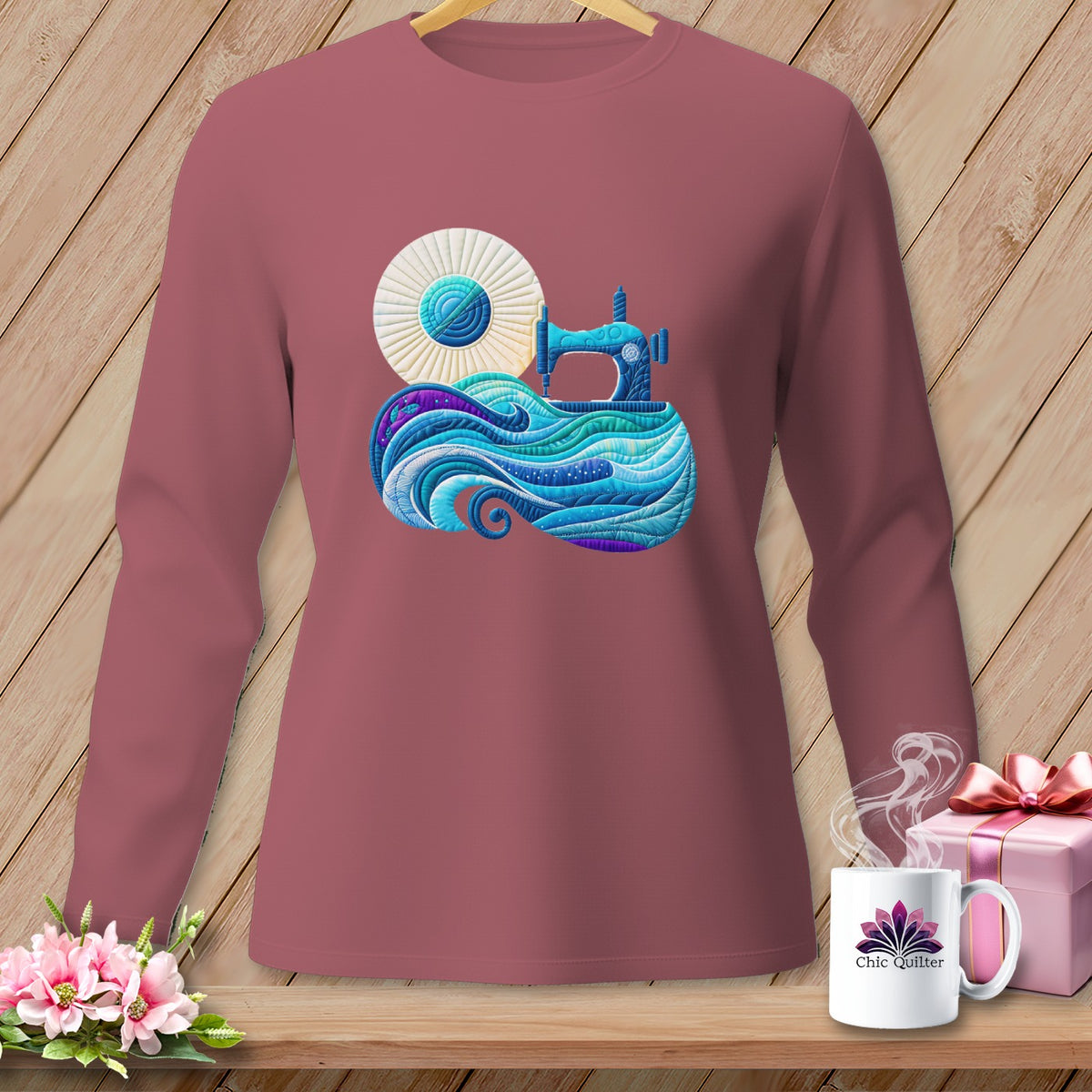 Long sleeve mauve shirt with a colorful sewing machine and fabric design on the chest.