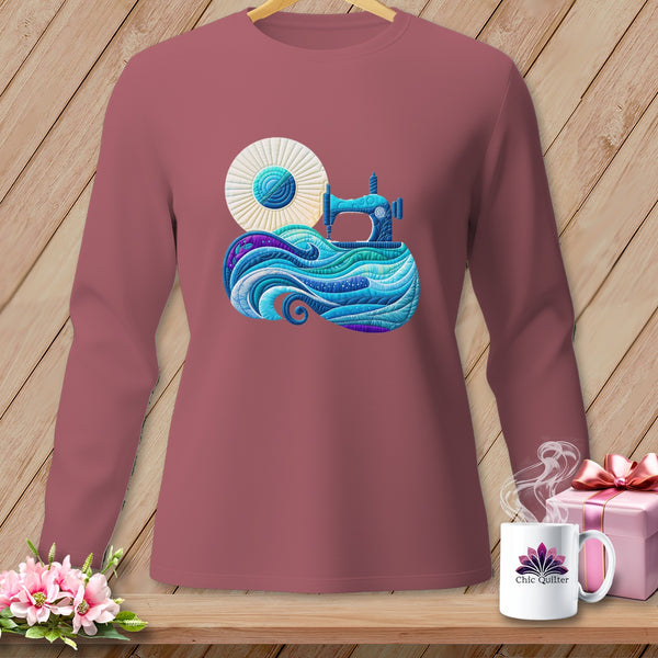 Long sleeve mauve shirt with a colorful sewing machine and fabric design on the chest.