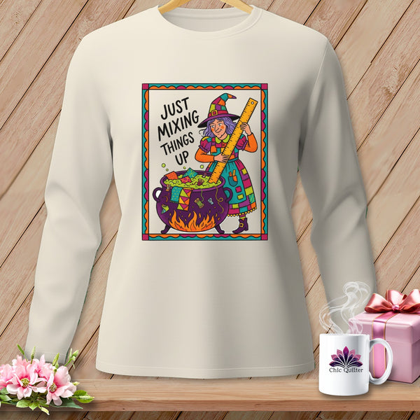 Cream long-sleeve shirt with "Just Mixing Things Up" witch graphic.