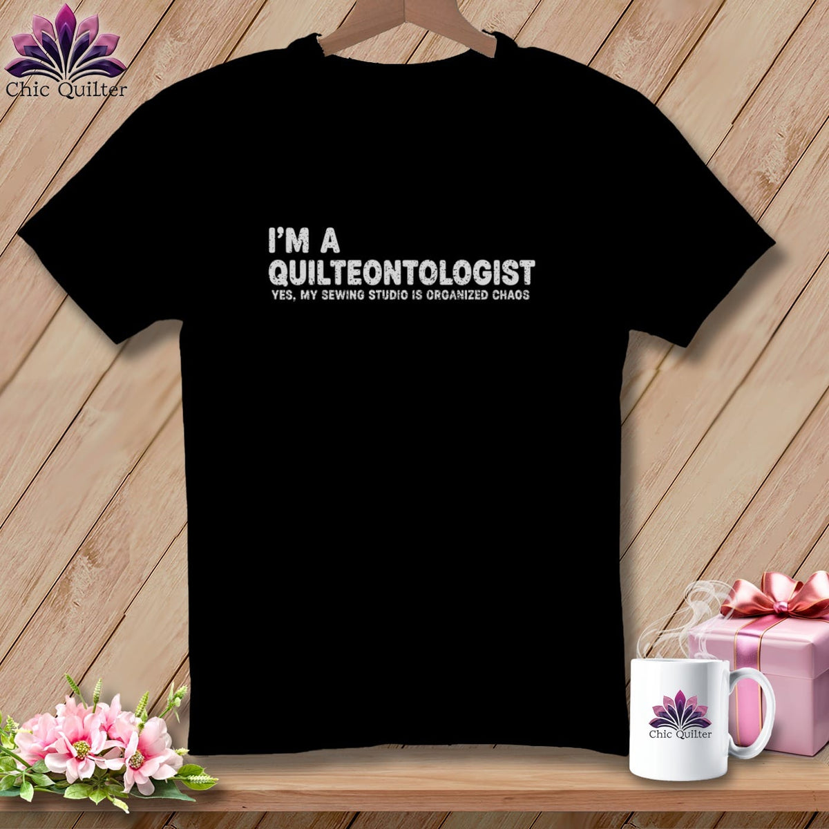 Black t-shirt with white text: "I'M A QUILTEONTOLOGIST YES, MY SEWING STUDIO IS ORGANIZED CHAOS."