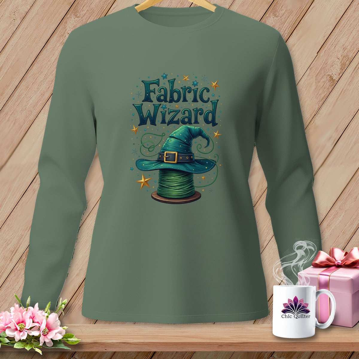 Green long-sleeve shirt with "Fabric Wizard" text and wizard hat on a spool of thread.