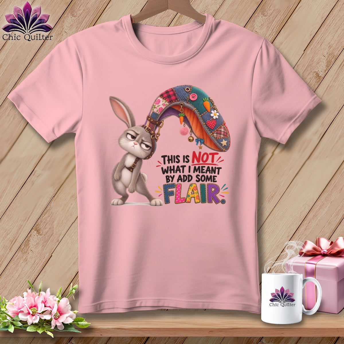 Pink t-shirt with cartoon bunny wearing a patchwork ear and text "THIS IS NOT WHAT I MEANT BY ADD SOME FLAIR".