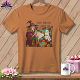 Orange t-shirt with witch and ghost graphic and text 