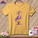 Yellow t-shirt hanging against a wooden background, featuring an illustration of a purple bird holding a sewing needle.