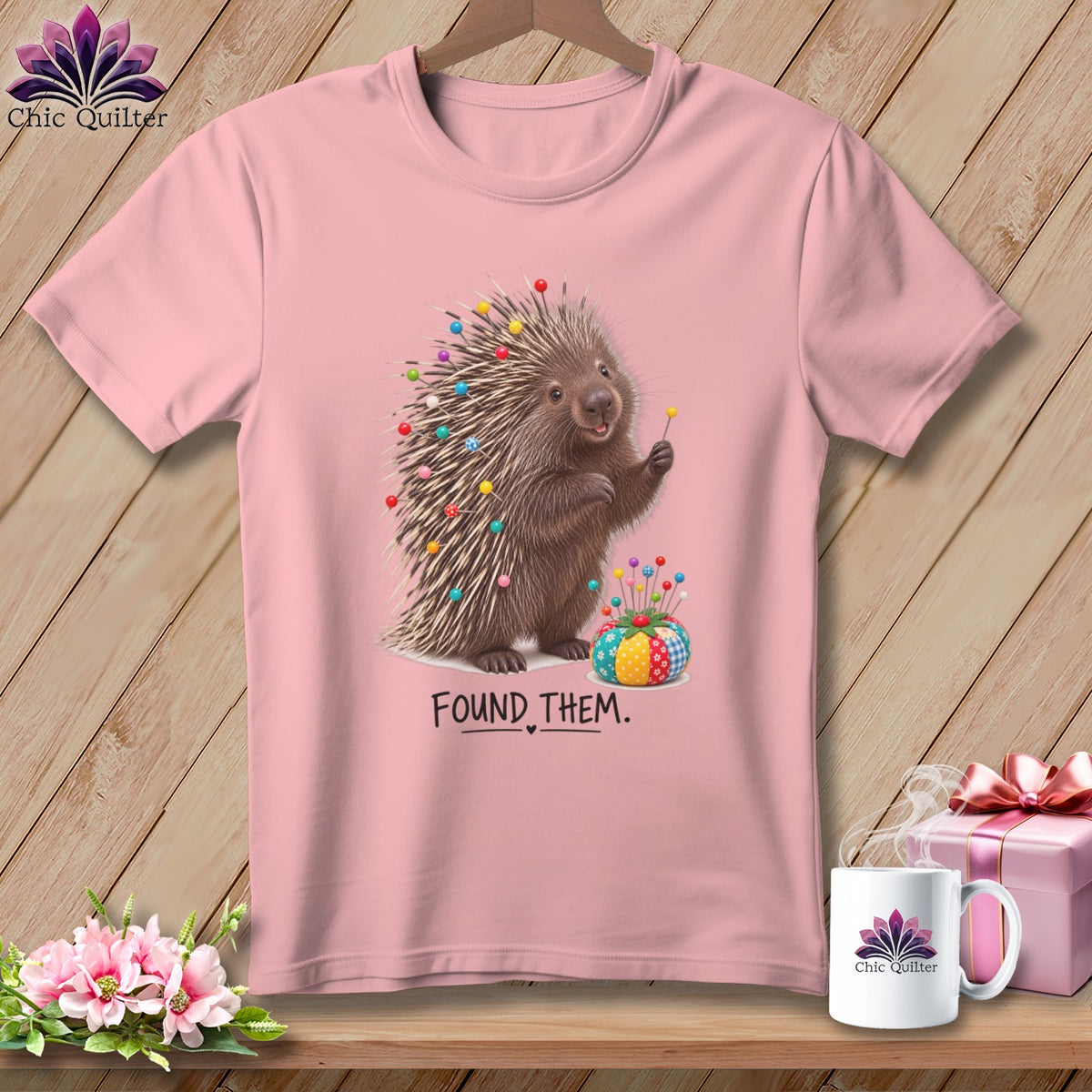 Pink t-shirt with a porcupine stuck with pins and the text "FOUND THEM."