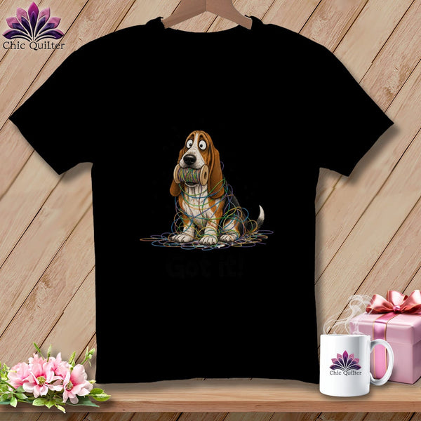 Black t-shirt with a cartoon basset hound tangled in colorful thread.