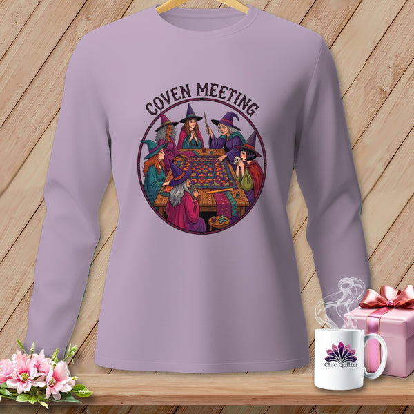 Witches gathered around a table with quilting supplies, with text "Coven Meeting" above.