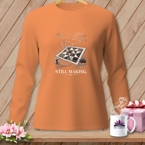 Orange long-sleeve shirt with quilting graphic and "STILL MAKING." text.