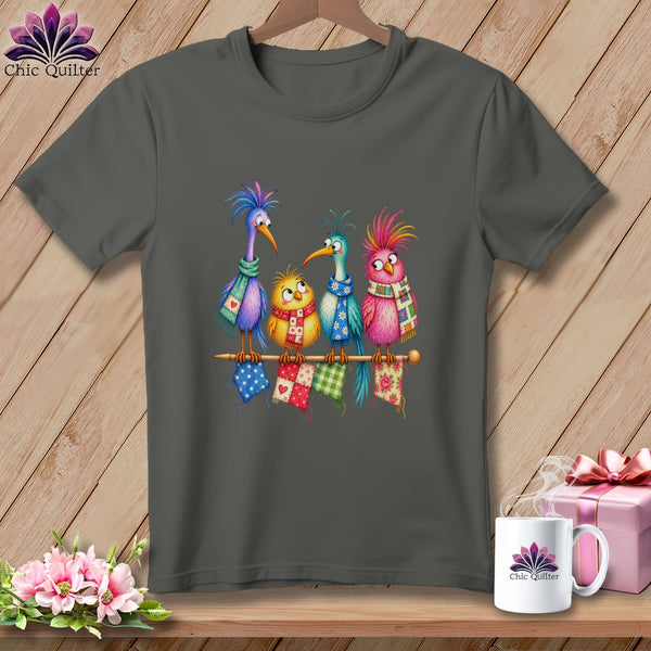Charcoal grey t-shirt featuring a colorful graphic of four whimsical cartoon birds wearing scarves on a knitting needle.