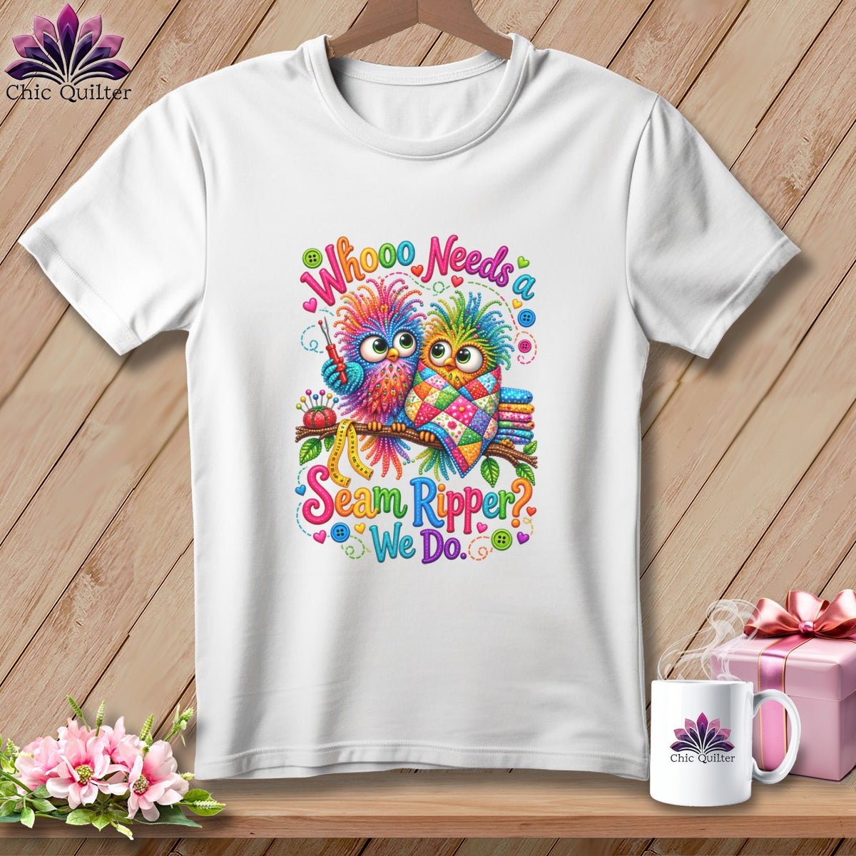 A white t-shirt features a colorful graphic of two owls and the text Whoooo Needs a Seam Ripper? We Do.
