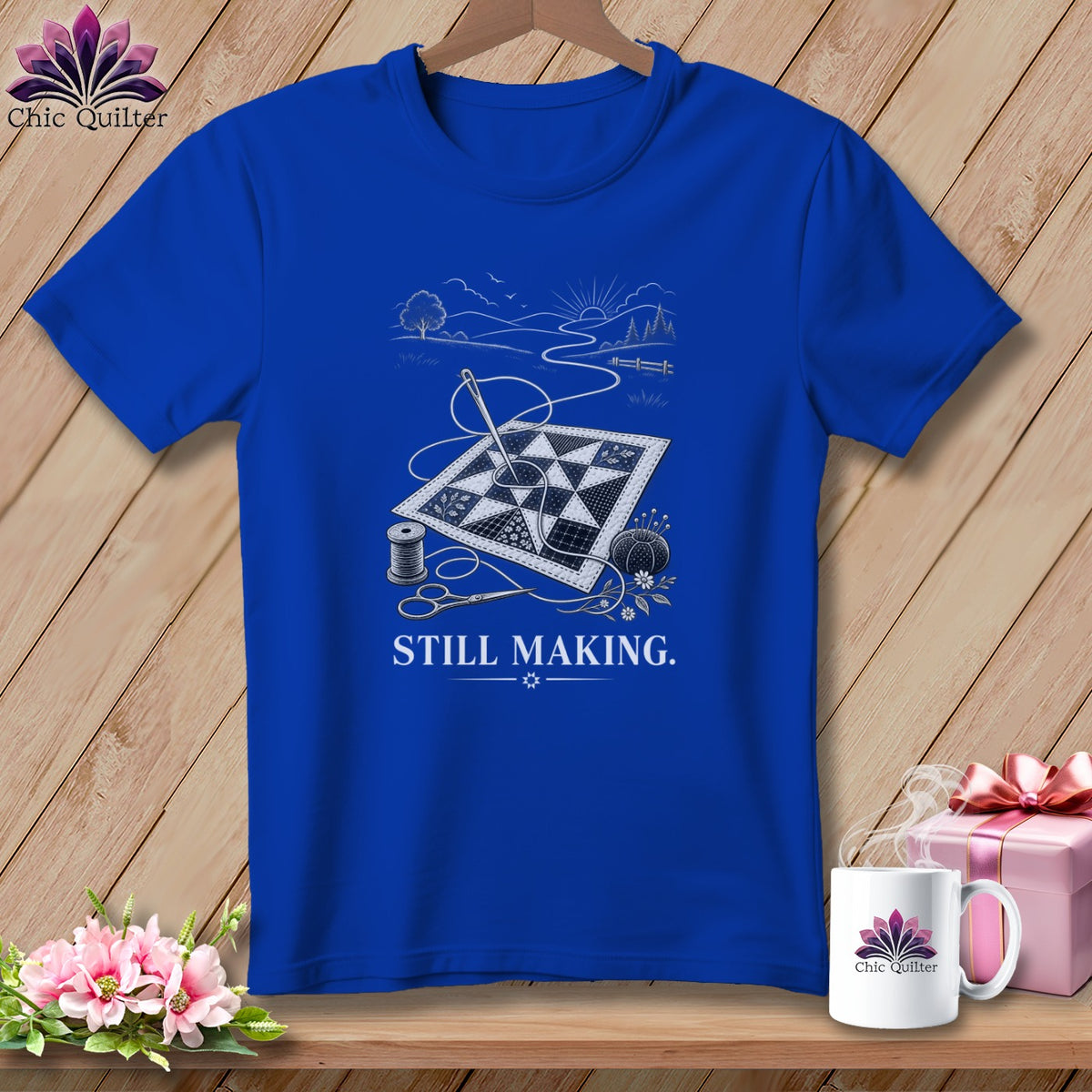 Blue t-shirt with quilting scene graphic and text "STILL MAKING."