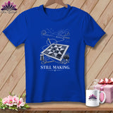 Blue t-shirt with quilting scene graphic and text 