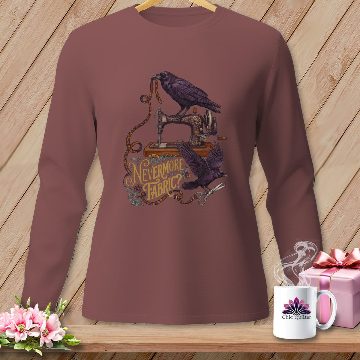 Long sleeve shirt with ravens, sewing machine, fabric, scissors, and text "Nevermore Fabric?".