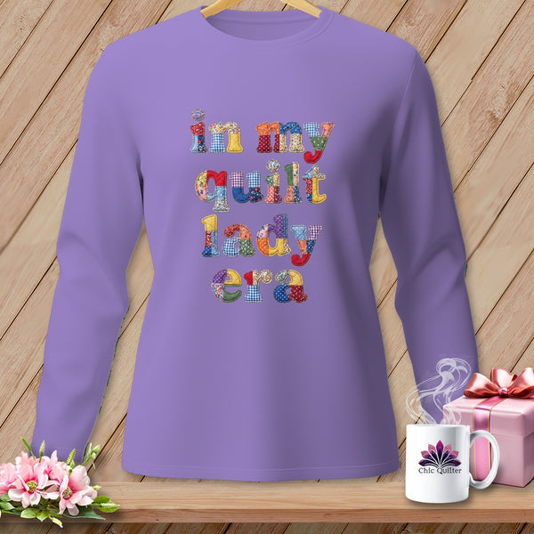 Purple long-sleeve shirt with "in my quilt lady era" text in patchwork letters.