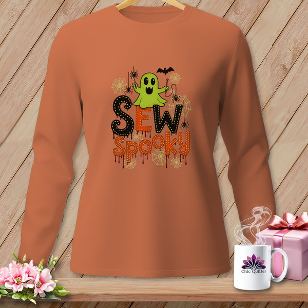 Orange long-sleeve shirt with a green ghost, spiders, and "Sew Spooky" text.
