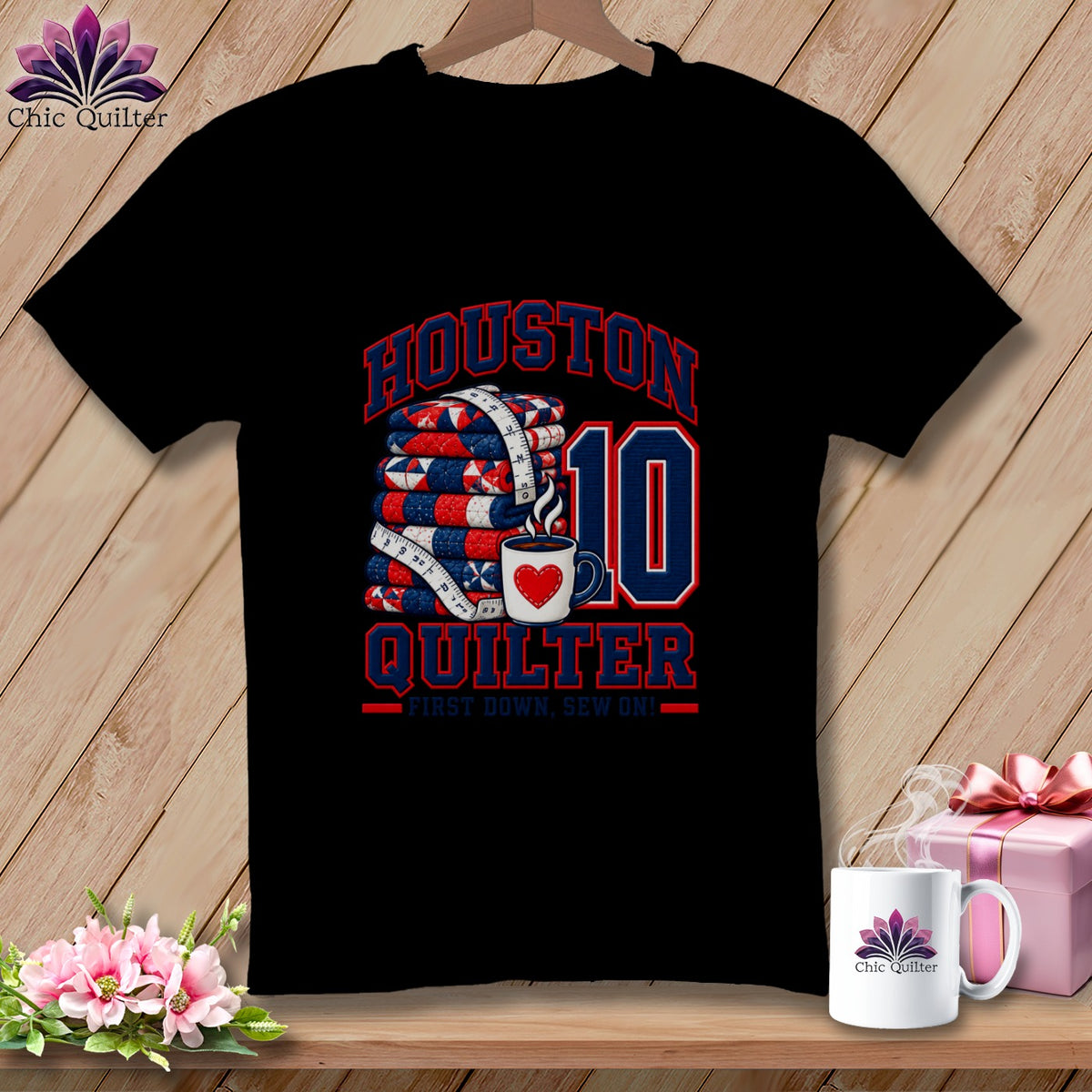 A black t-shirt features a red, white, and blue graphic that reads Houston Quilter with a stack of quilts and a coffee mug.