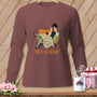 Brown long-sleeve shirt with a graphic of a woman and cat sewing a quilt, and the text "HEX THE SEAM".
