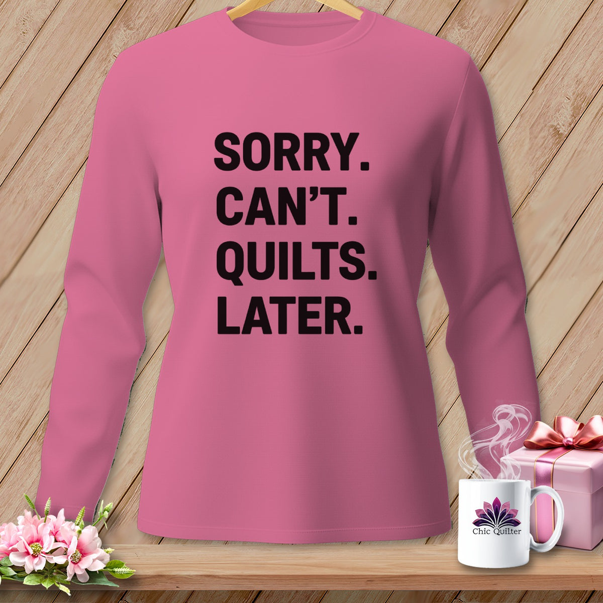 Pink long-sleeve shirt with black text "Sorry. Can't. Quilts. Later."