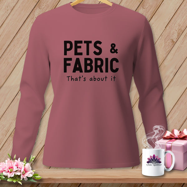 Pink long-sleeve shirt with black text "PETS & FABRIC That's about it".
