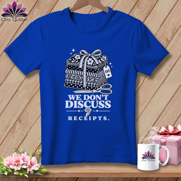Blue t-shirt with "We Don't Discuss Receipts" and sewing supplies graphic.