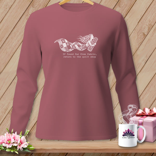 Long sleeve shirt with a girl and quilt graphic and text.